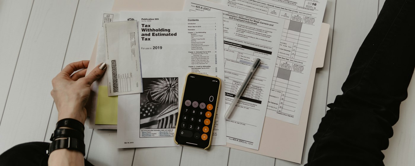 Financial statements, calculator and reports on a desk